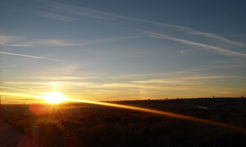 Scenic view of field against sky during sunset