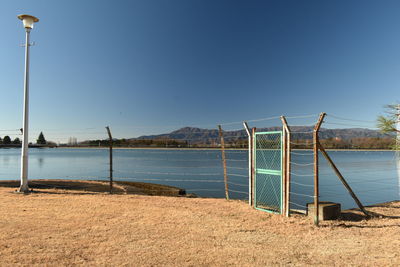 Scenic view of lake against clear blue sky