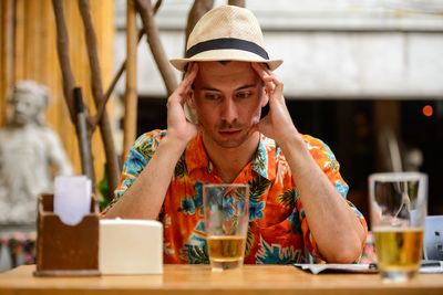 Depressed man sitting in cafe