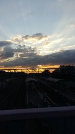 Railroad tracks against sky during sunset