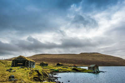 An old abandoned hamlet in the faroe islands. mountains and lake on background. high quality photo