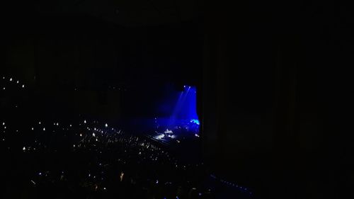 View of illuminated music concert at night