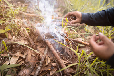 Camping concept, starting campfire with fire starting tools,cooking.