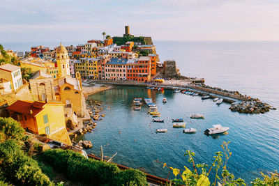 High angle view of buildings by sea against sky