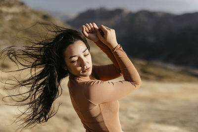 Young woman standing at beach