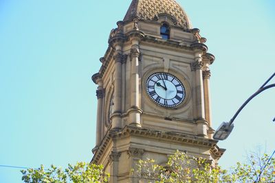 Low angle view of clock tower against sky