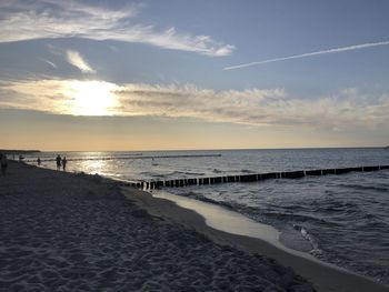 Scenic view of beach against sky during sunset