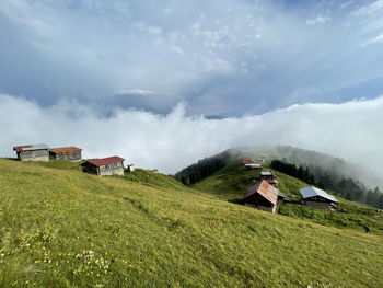 Houses on field against sky