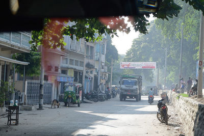 Cars on street amidst buildings in city