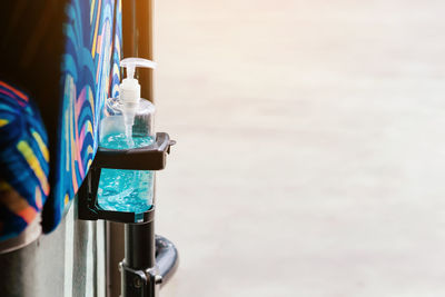 Close-up of sanitizer bottle on rack