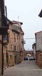 Street amidst buildings in city against clear sky