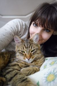 Portrait of woman with cat at home