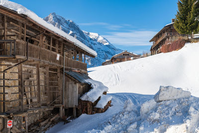 Snow covered buildings against sky