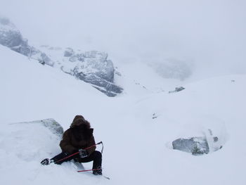 Rear view of person on snow covered mountain