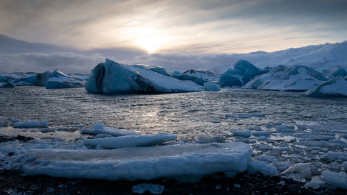 Scenic view of frozen lake against sky during winter