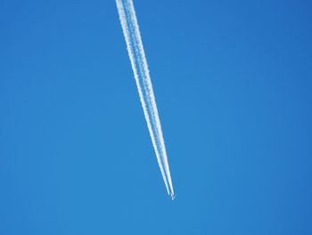 Airplane flying against clear blue sky