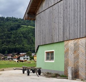 House by building against sky