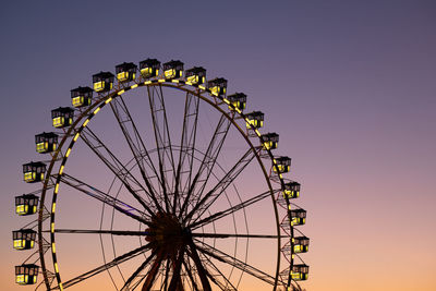 Ferris wheel against sunset