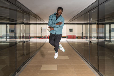 Active african american man jumping in corridor