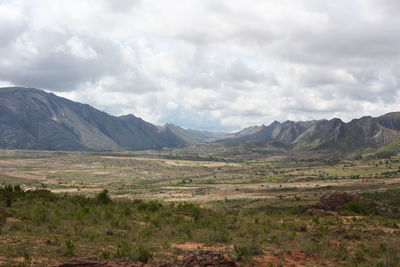 Scenic view of mountains against cloudy sky