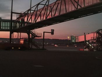 Illuminated bridge against sky at night in city