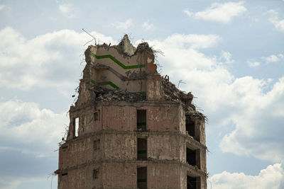 Low angle view of a demolished building against the sky