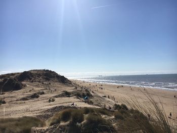 Scenic view of beach against clear blue sky