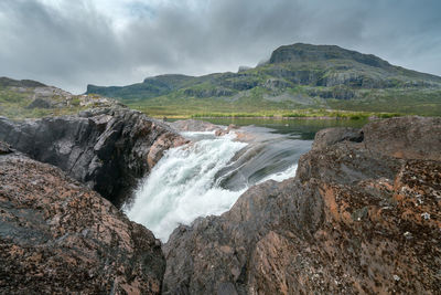 Closeup, wide, low angle shot of mighty stuor muorkkegarttje waterfall on lulealven river