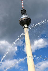 Low angle view of communications tower against sky