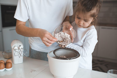 Midsection of boy holding coffee at home