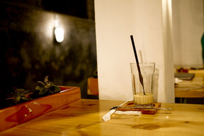 Close-up of illuminated lamp on table