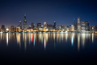 Illuminated city at waterfront