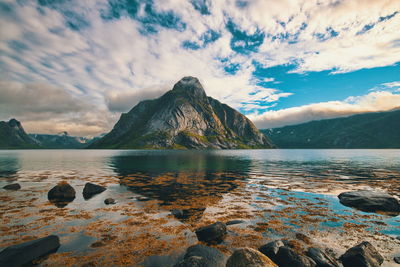 Scenic view of sea and mountains against sky