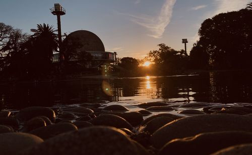 Scenic view of lake against sky at sunset