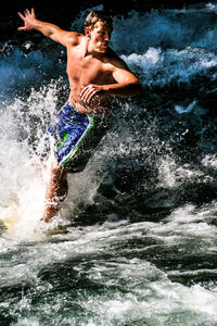 Woman jumping in water