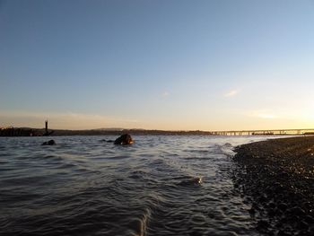 Scenic view of river against sky during sunset