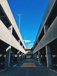 Road against blue sky in city