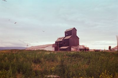 Built structure on landscape against sky