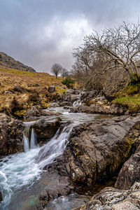 Scenic view of waterfall against sky