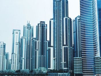 Modern buildings in city against clear sky