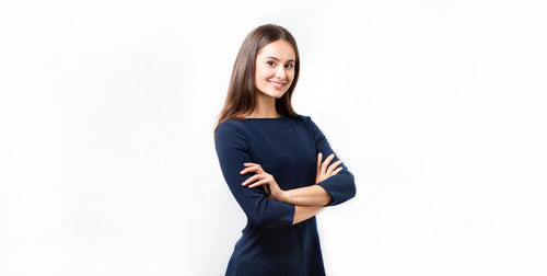 Portrait of a smiling young woman against white background