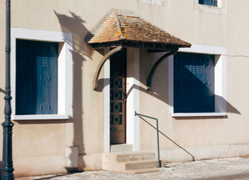 Entrance door of a french house with a lantern shadow