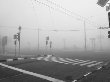 Vehicles on road against clear sky