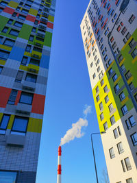 Low angle view of buildings against blue sky