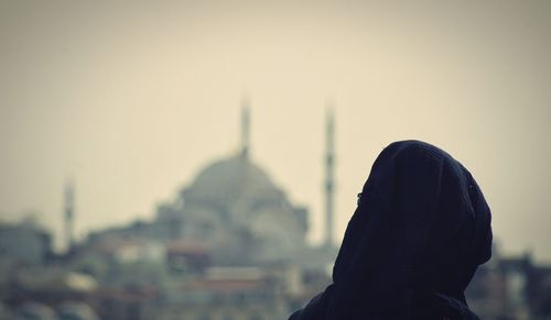 Portrait of man against sky in city