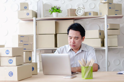 Mid adult man using laptop on table