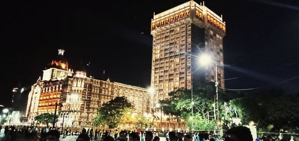 Group of people in illuminated building at night