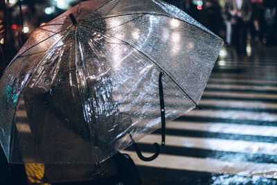 Close-up of wet umbrella in city during rainy season