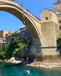 Low angle view of bridge over river against sky