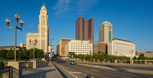 City street and modern buildings against sky